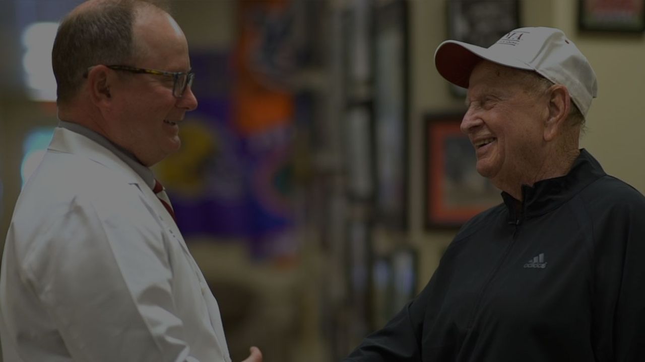 Paul Smith shaking hands with Dr. Corbett